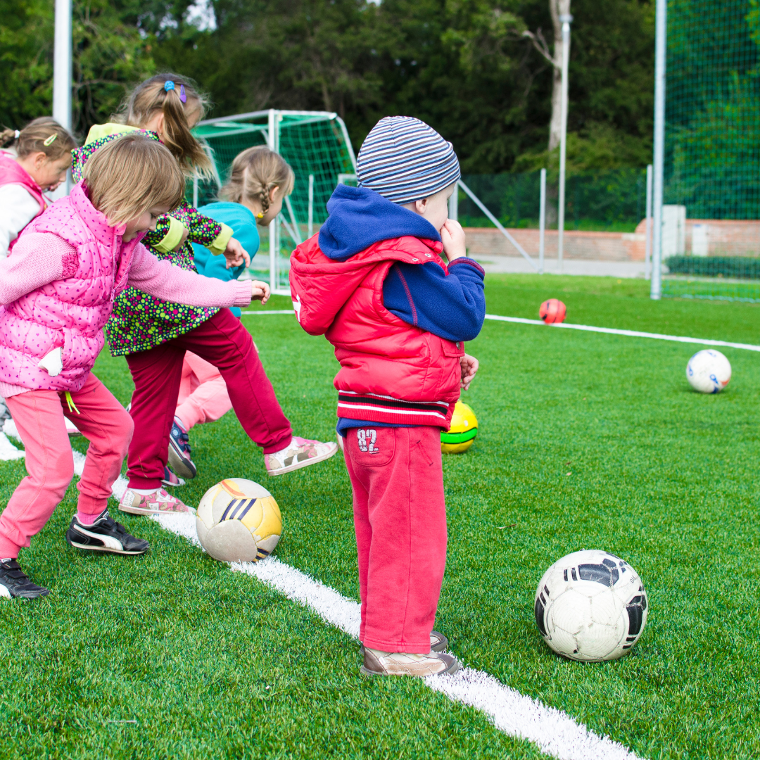 Young children playing with soccer balls outside - UCCC at Armitage Village PS childcare programs