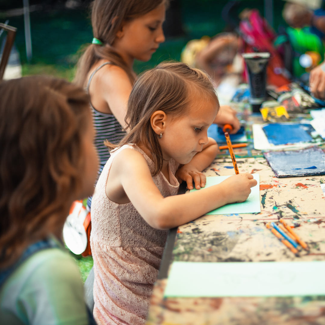 School age children doing art activity inside