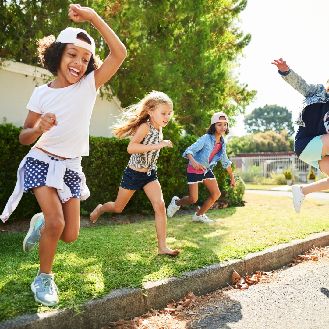 School age kids jumping outside