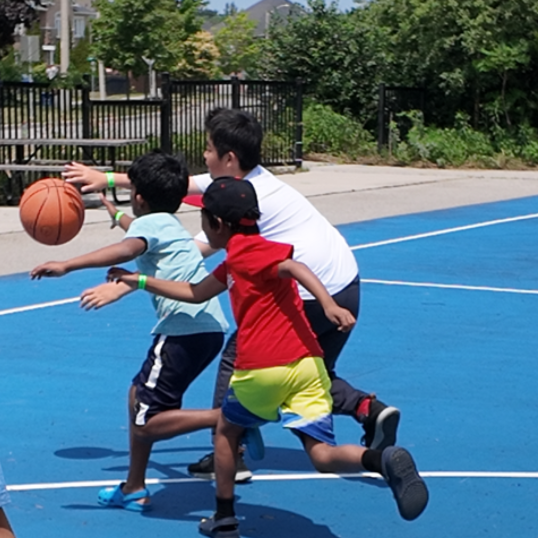 Three kids playing basketball outside - Before and After School at Teston Village PS