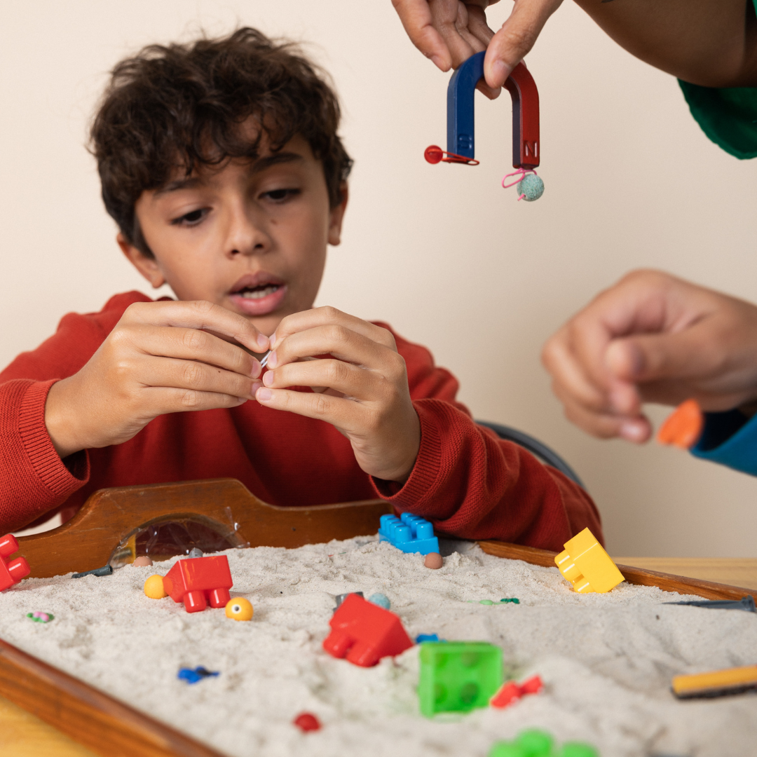 Children doing table activity with magnets