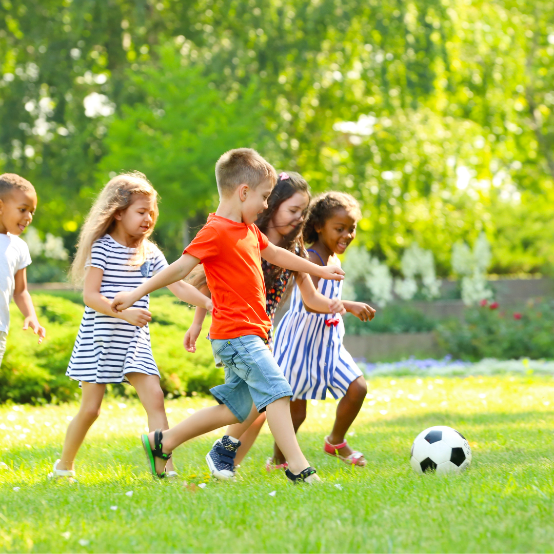 Kids playing soccer outside - Before and After School at Wellington PS