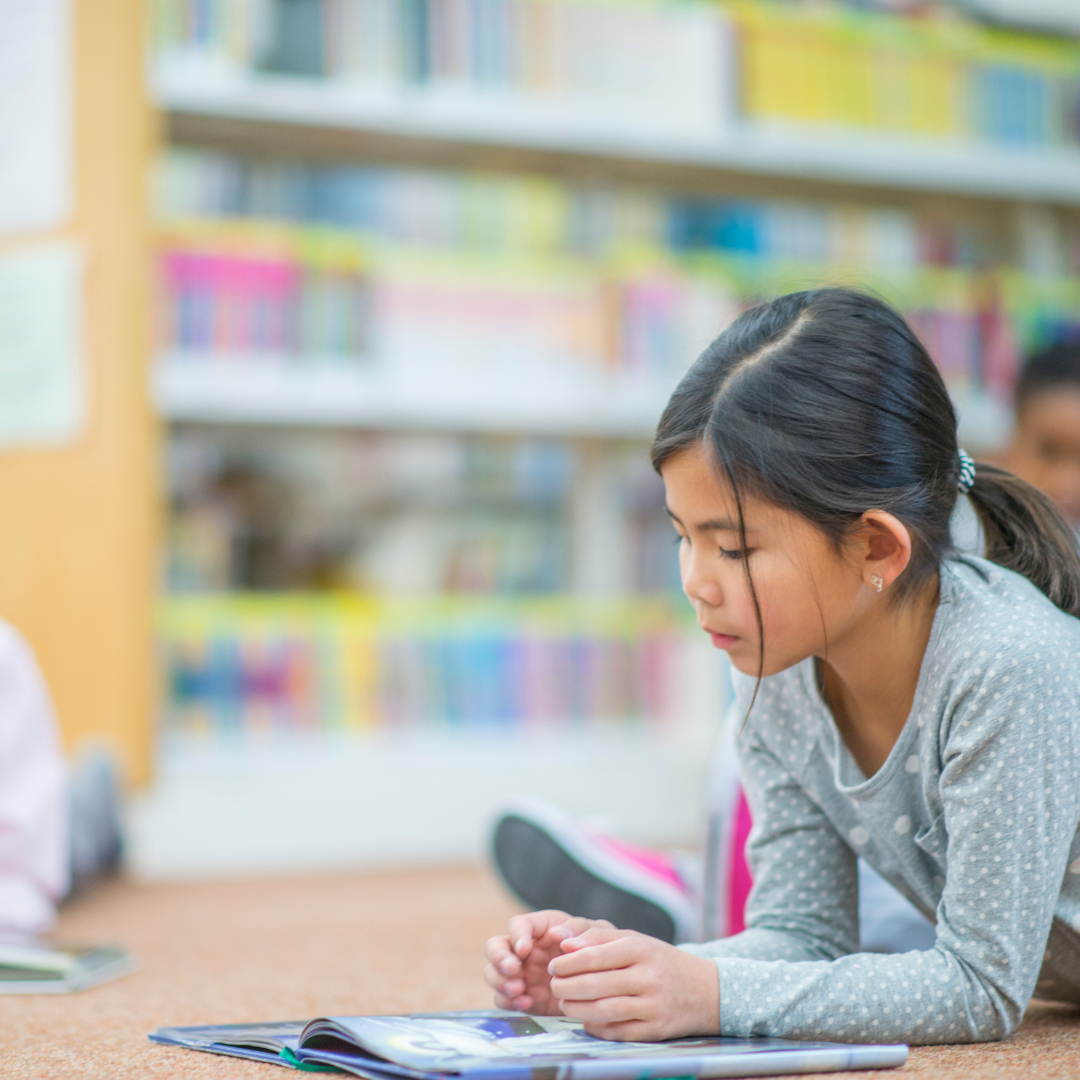 School age children reading in the library