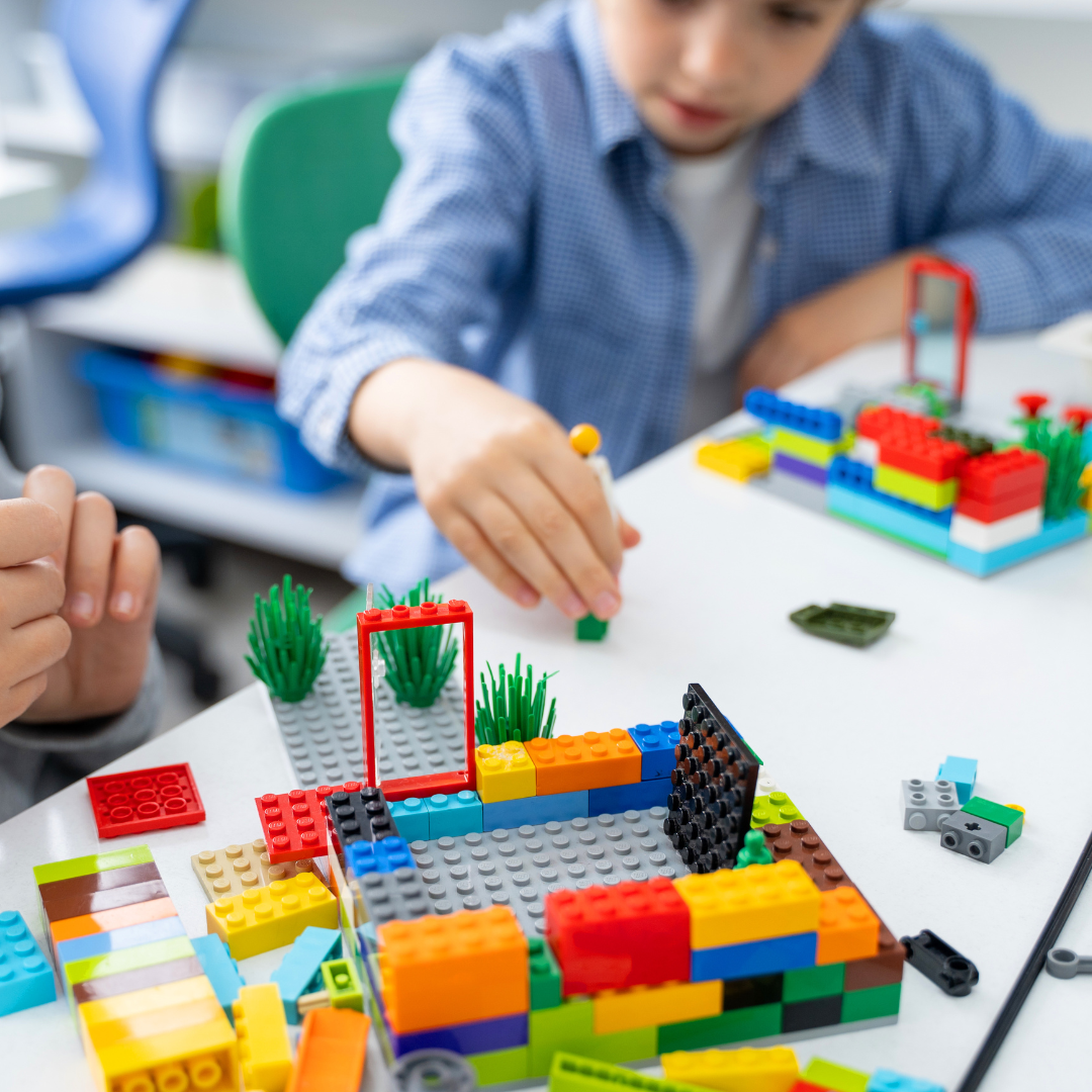 Children building inside with Lego