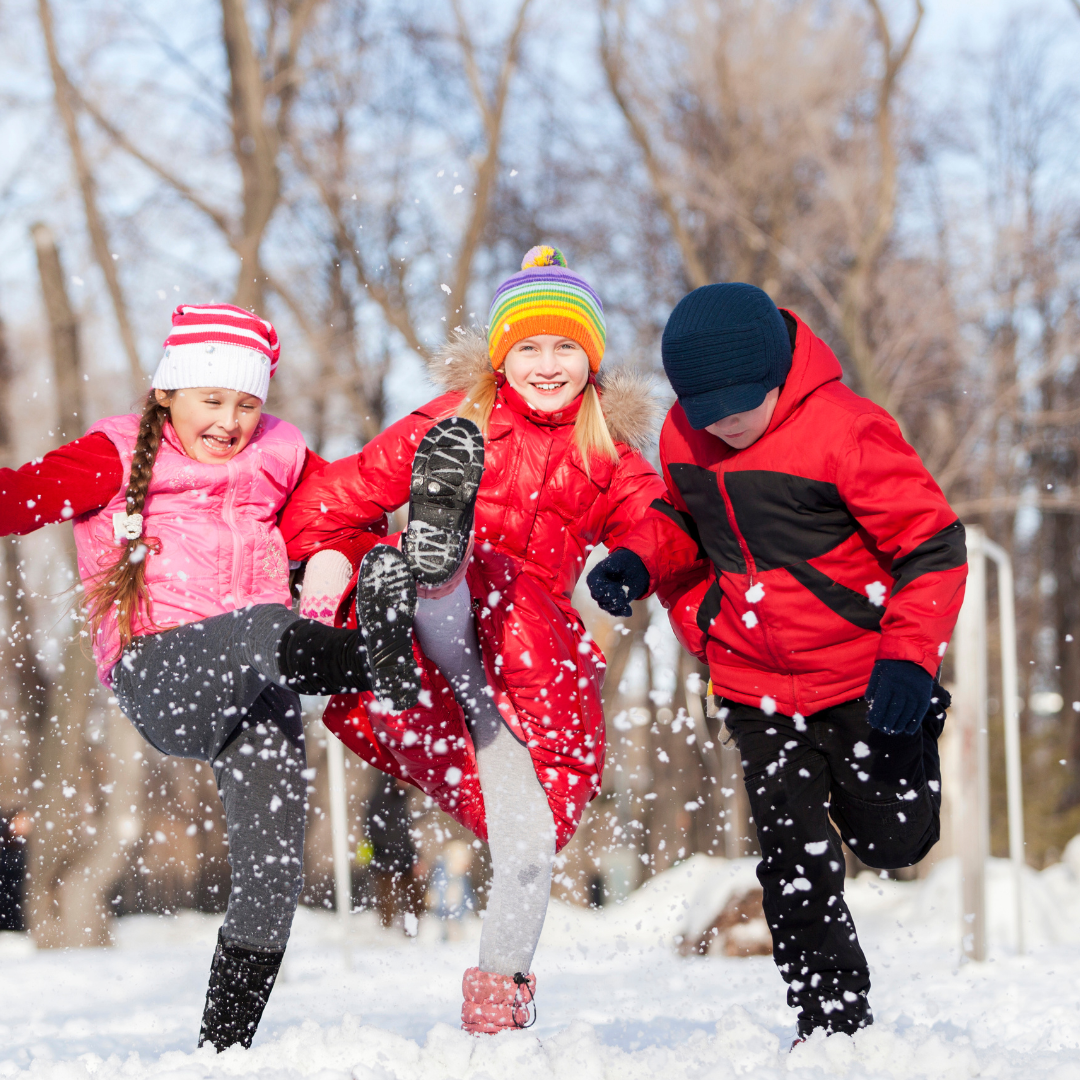 Children kicking snow up into the air in winter - Before and After School at Wismer PS