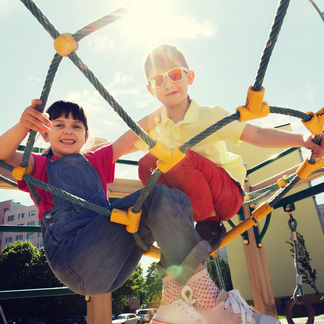 Kids playing on playground structure on a sunny day