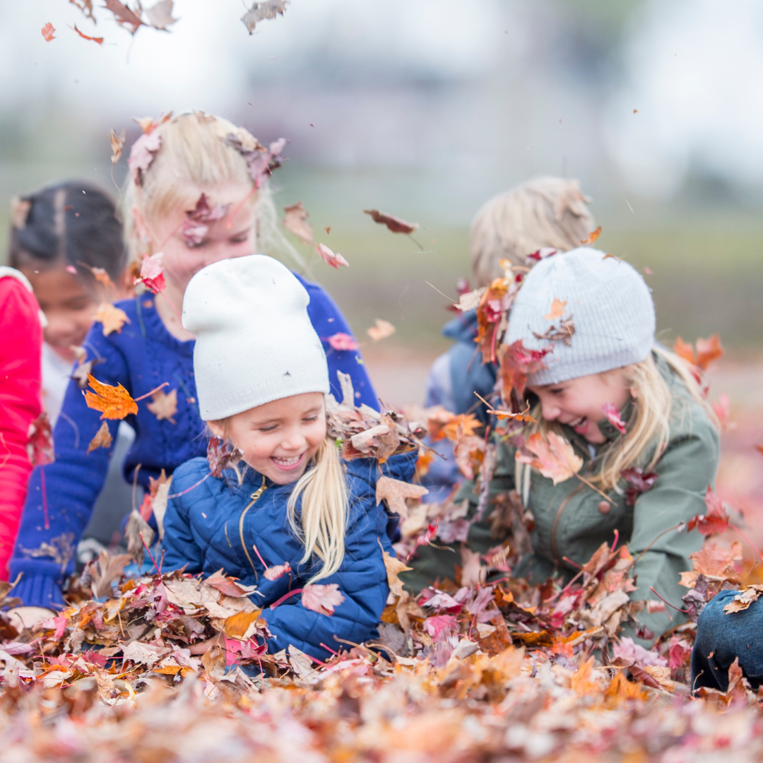 Kids playing in leaves
