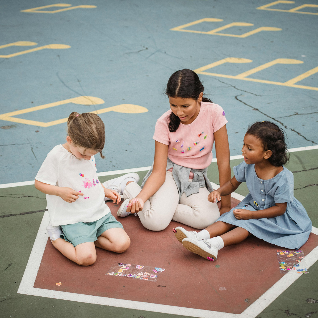 Children sitting outside in school yard