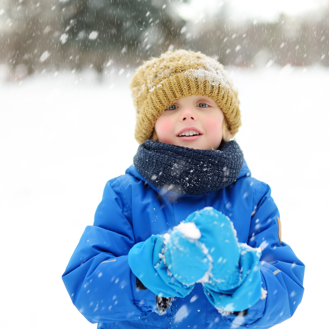 Child dressed for winter, standing outside in snow - UCCC at Armitage Village PS childcare programs