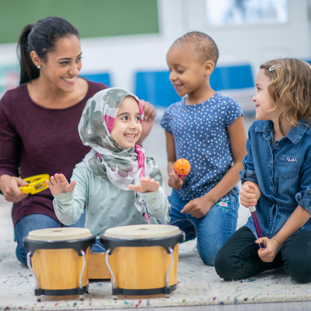 Adult and children doing music activity - Before and After School at St. Brendan CES