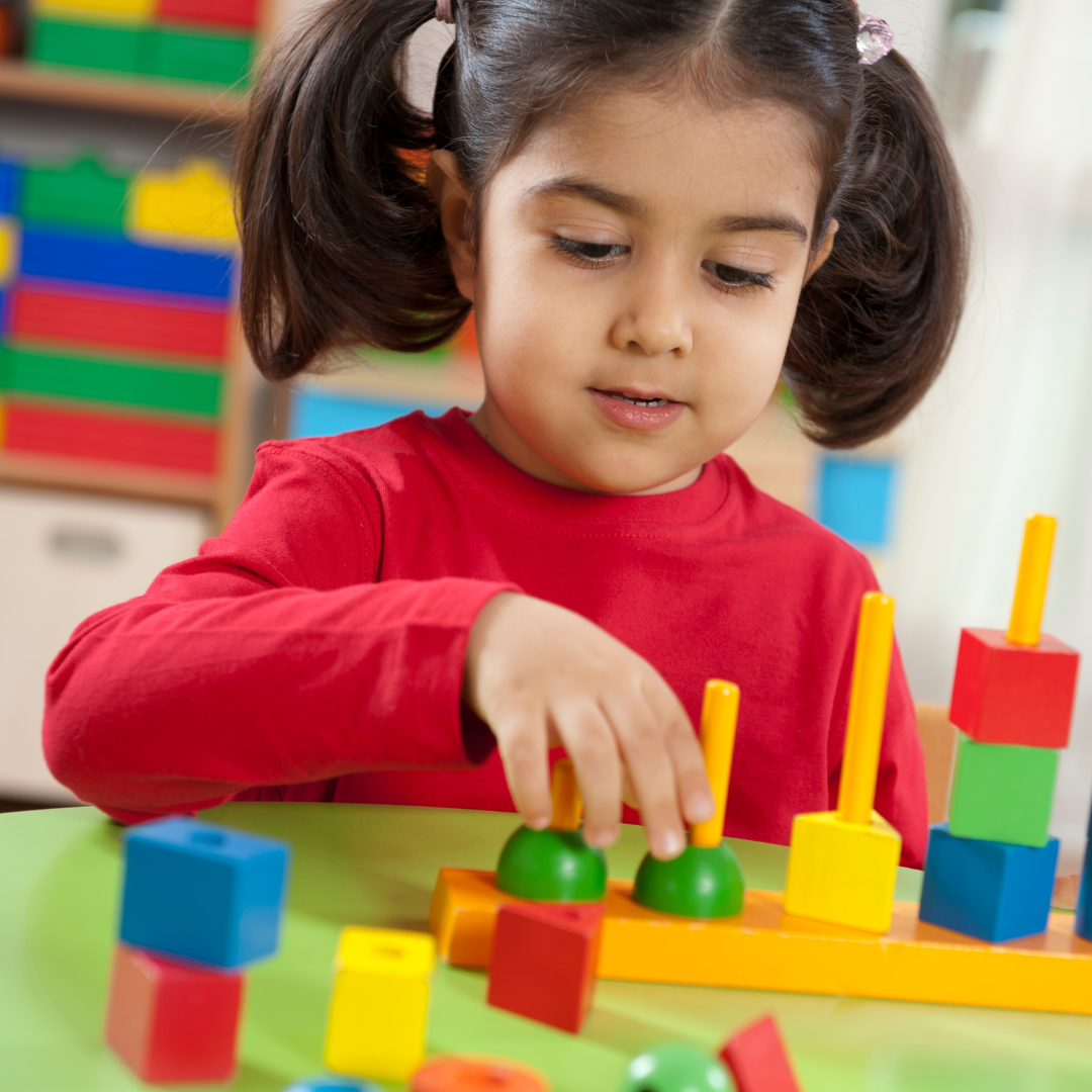 Child playing with stacking toy