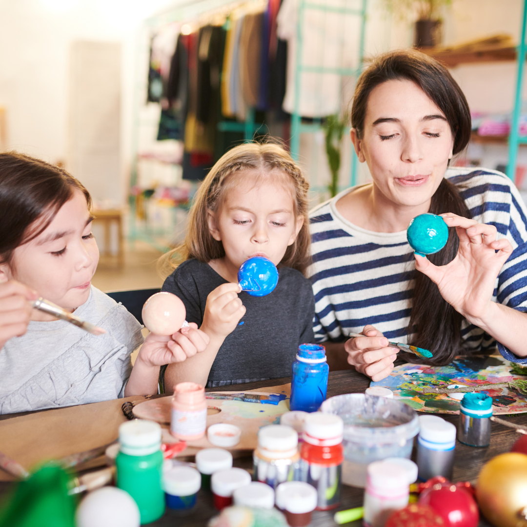 Children and adult doing art project together