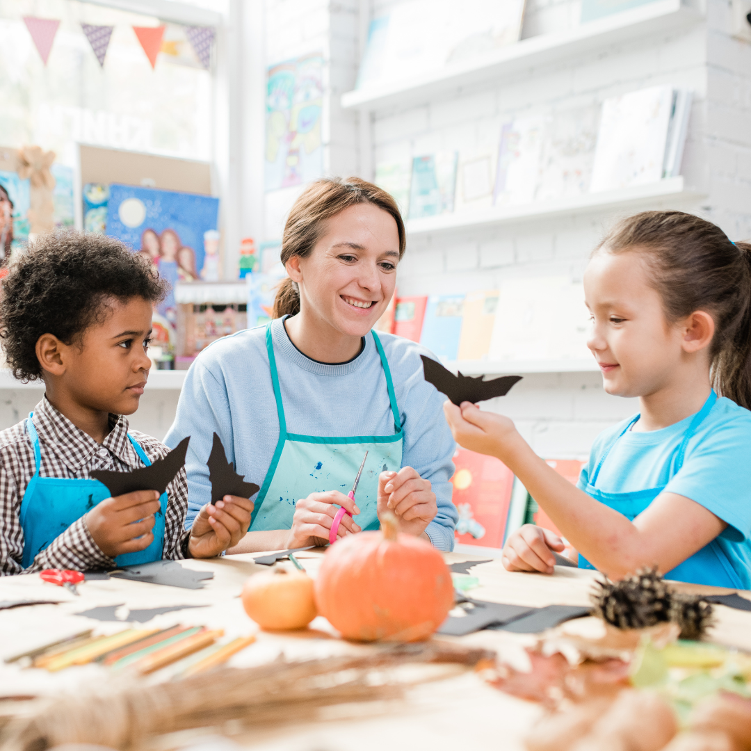 School age children and adult doing art activity
