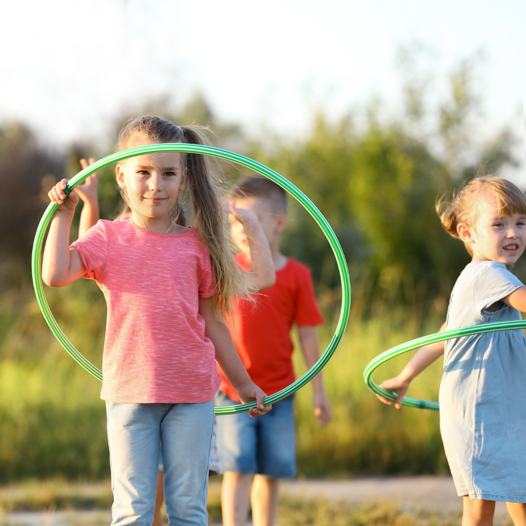 Kids playing with hula hoops outside - Before and After School at Fred Varley PS