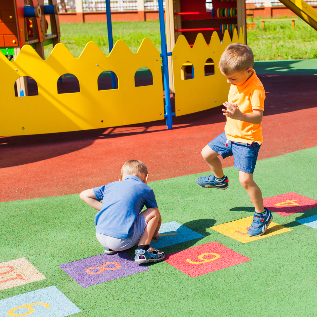 Two kids playing outside in playground