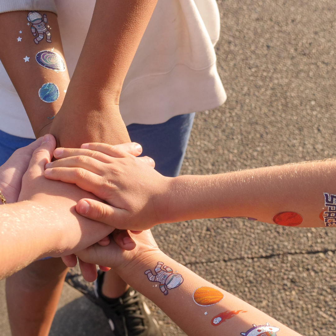 Kids team huddle - putting hands in centre