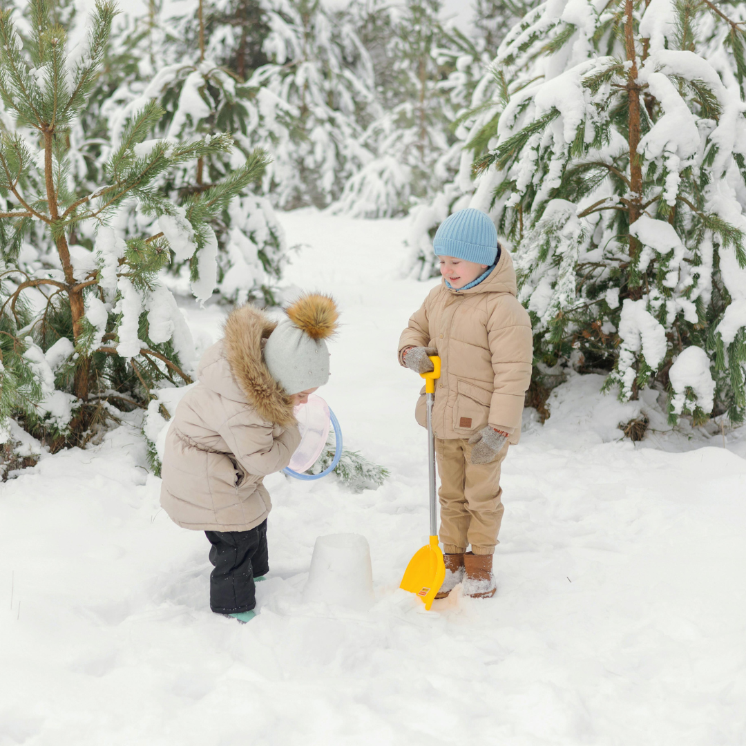Two children playing in the snow