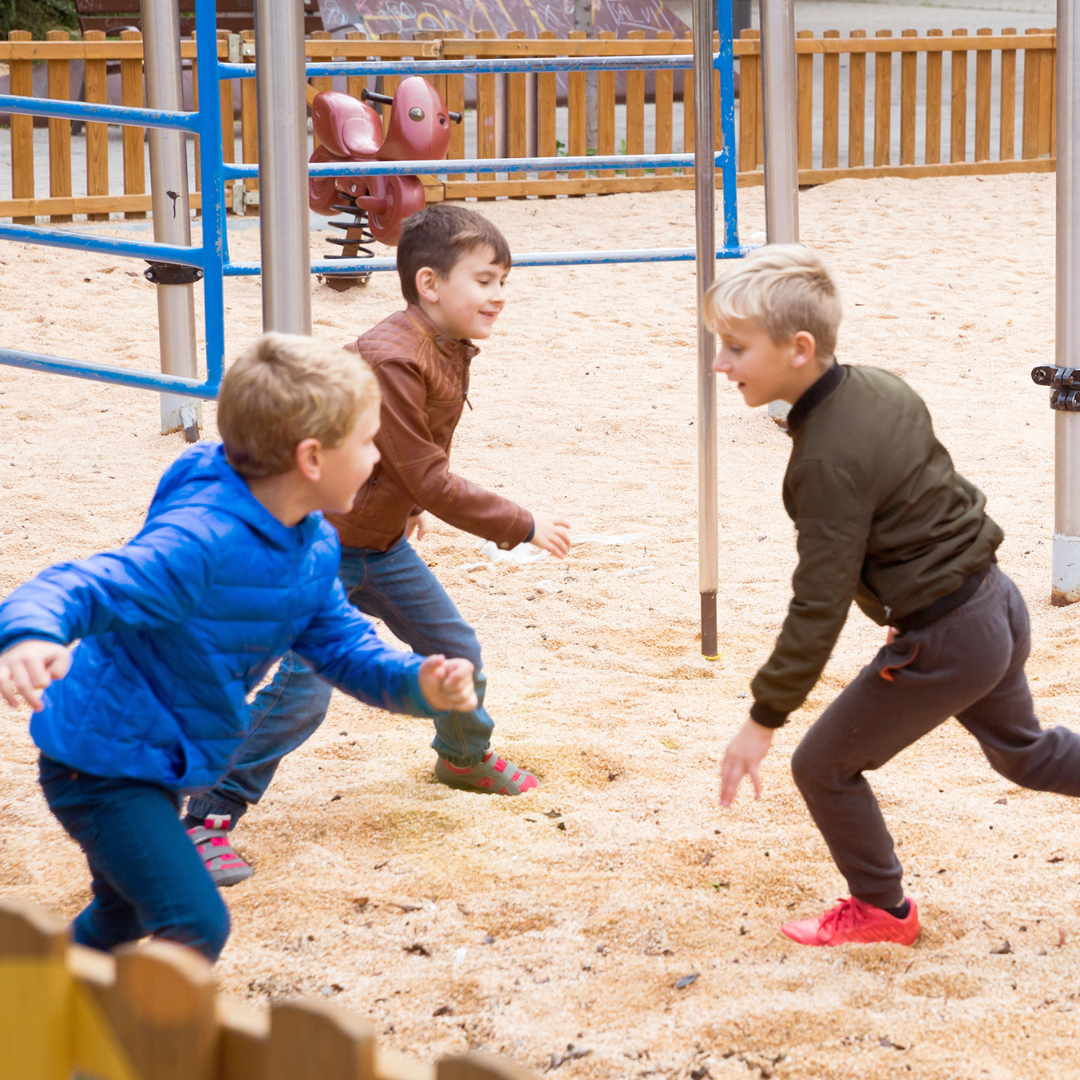 School age kids playing in a sandy playground