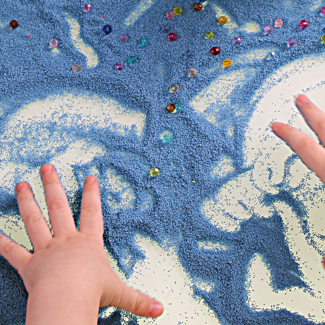 Children's hands playing with sensory sand
