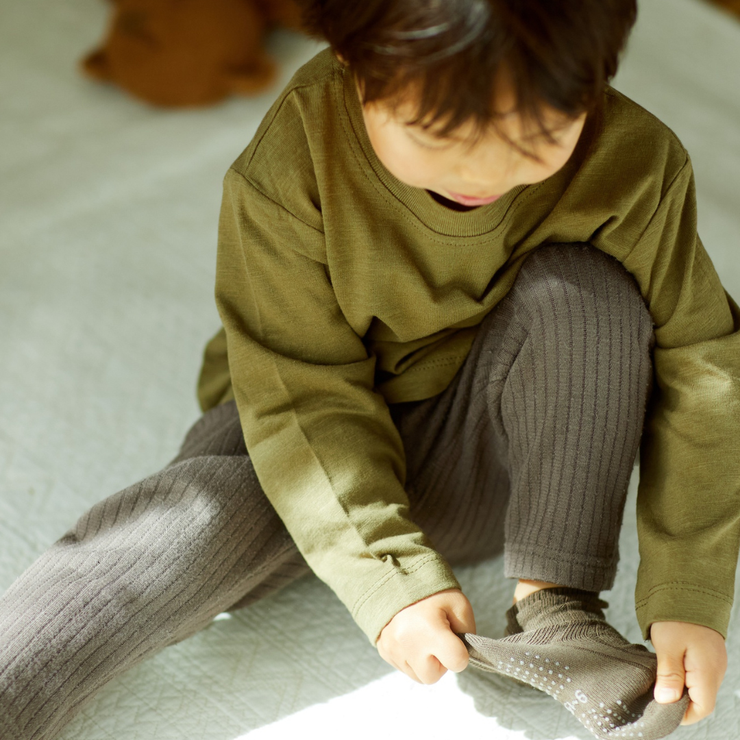 Child putting on a sock