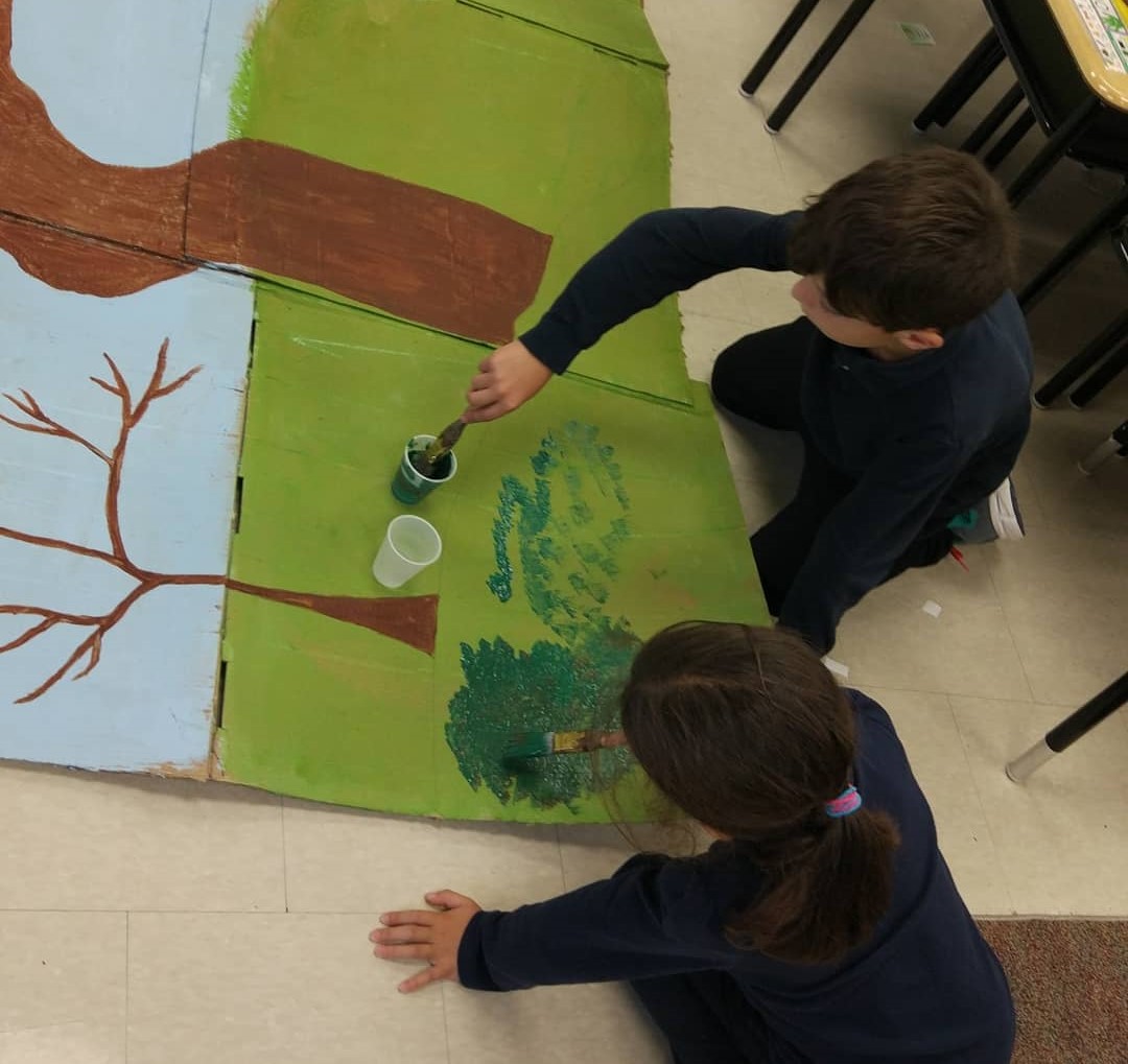 School age kids painting theatre sets - Before and After School at Holy Name CES