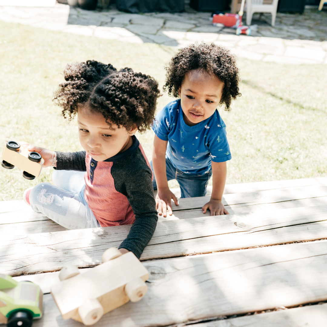 Two children sitting at picnic table