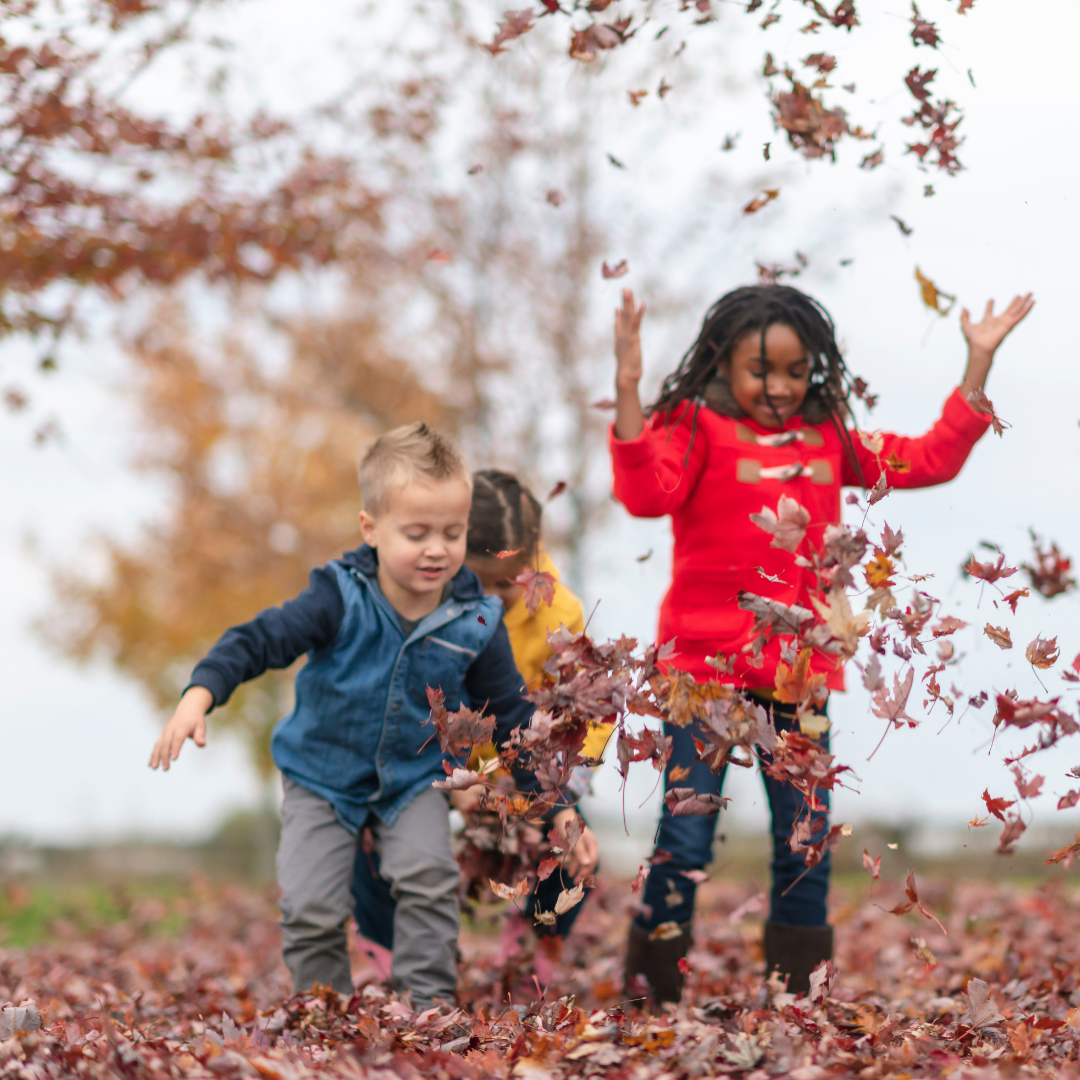 Children playing outside in autumn leaves - Before and After School at Elder's Mills PS