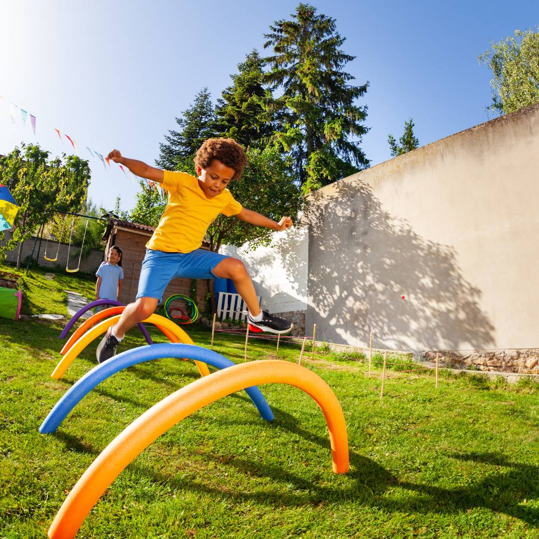 Child outside jumping over obstacle course - Before and After School at Clearmeadow PS
