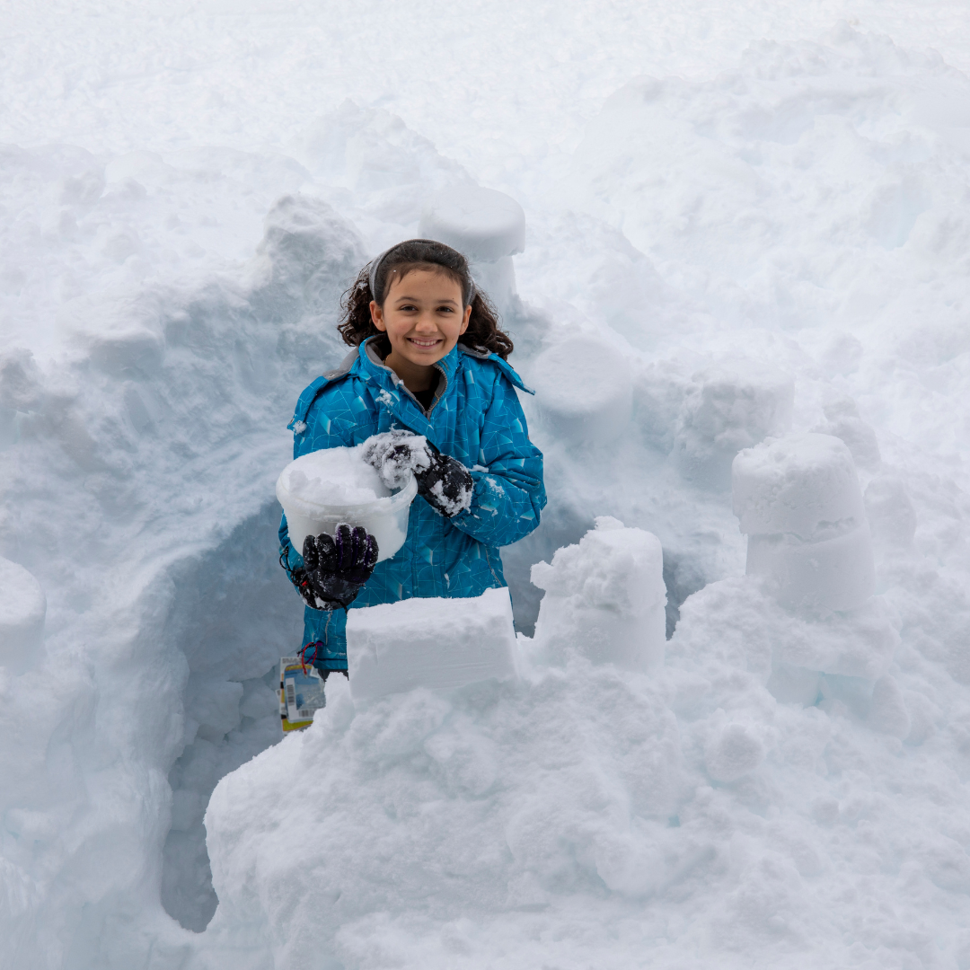School age child building in the snow