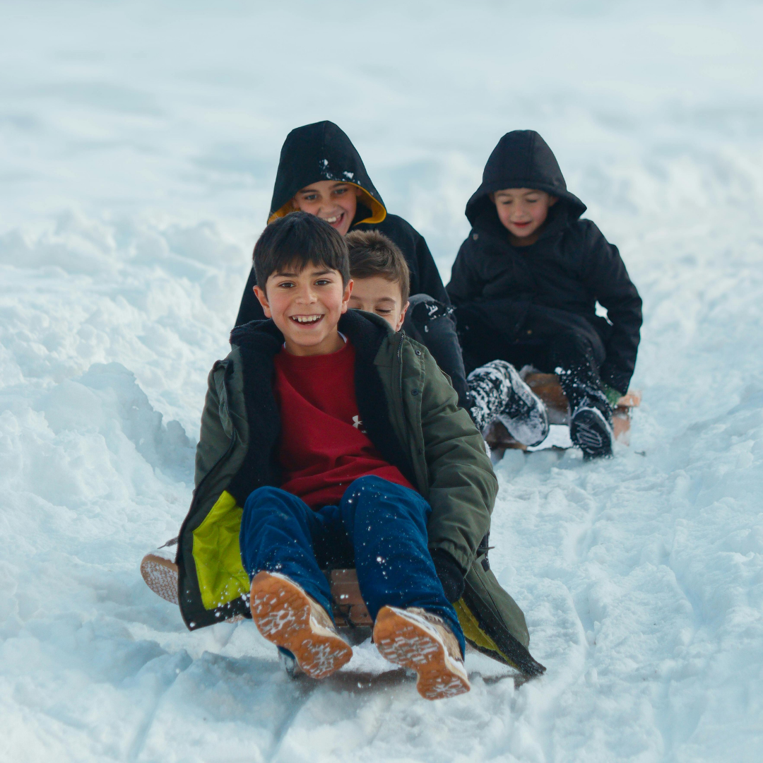 Kid sledding in snow