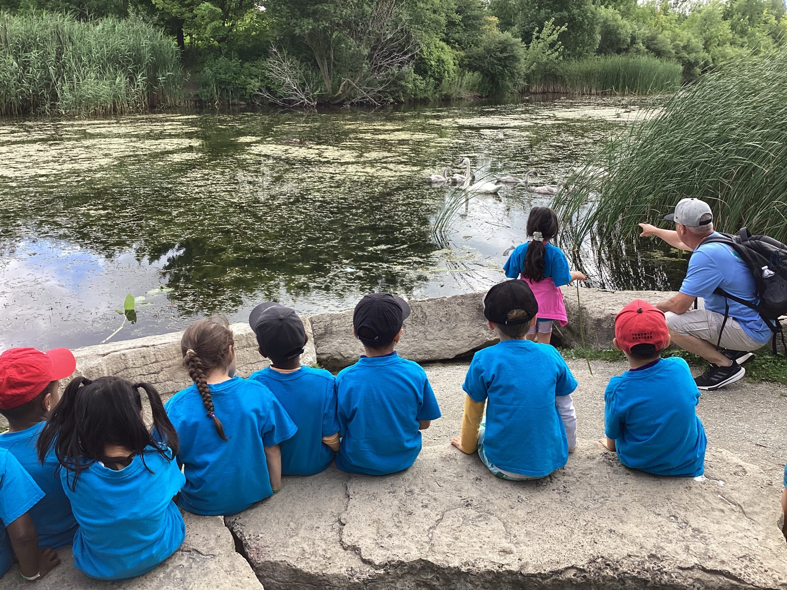 Campers and staff sitting by the water