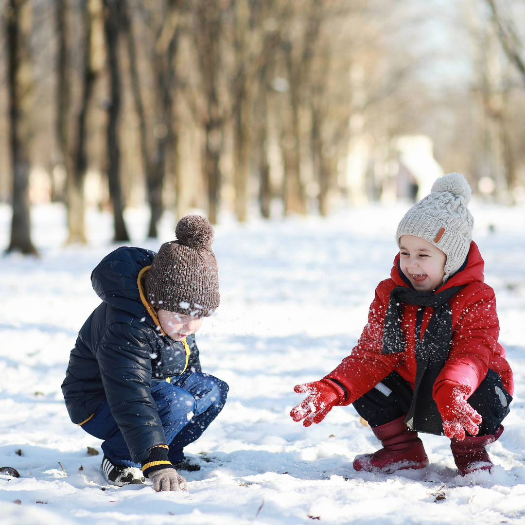 Children playing in a park in the winter