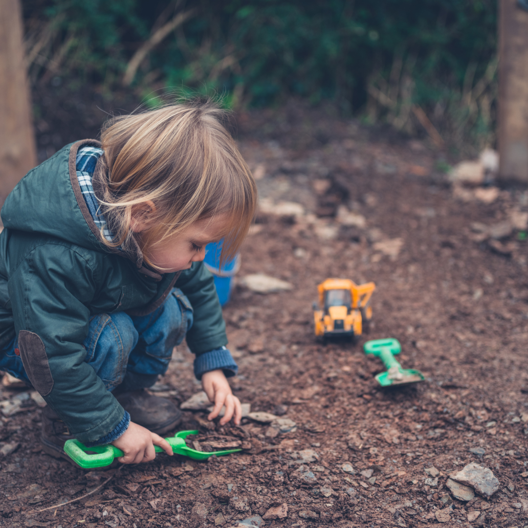 Toddler digging outside in nature