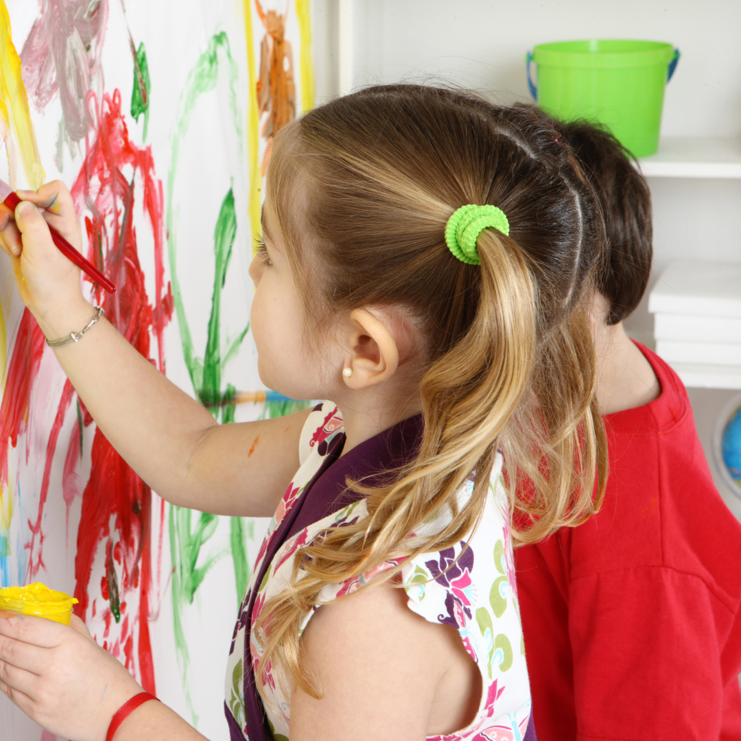 Children standing and painting pictures
