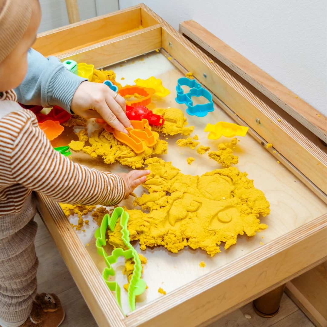 Children playing in sensory sand bin