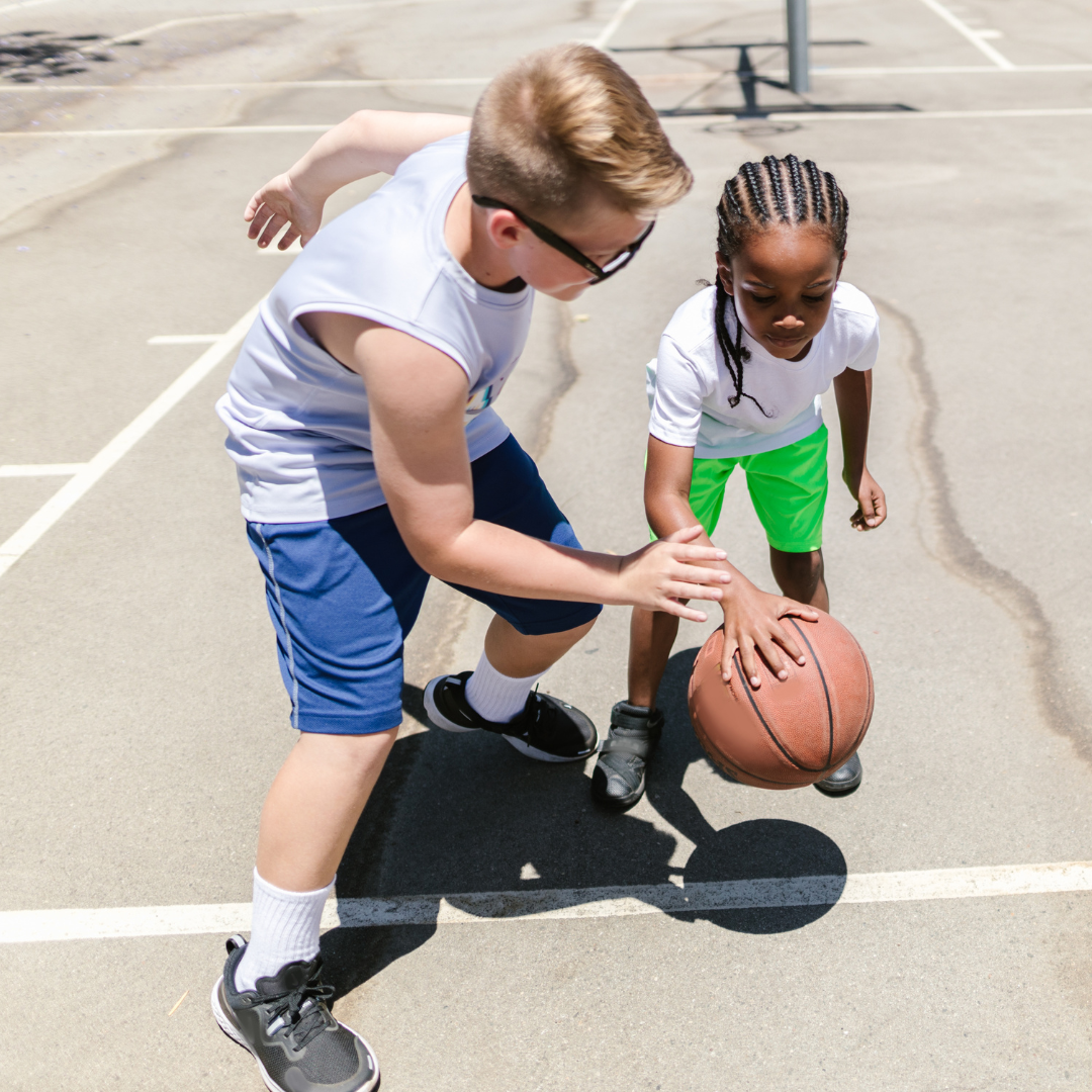 Adult and child playing basketball