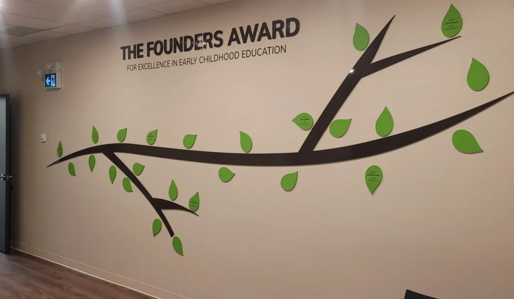 The Founders Award Wall, tree with leaves, featuring award winners' names