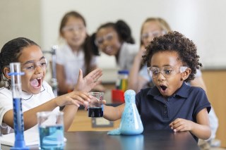 Children looking happy and excited doing science experiments