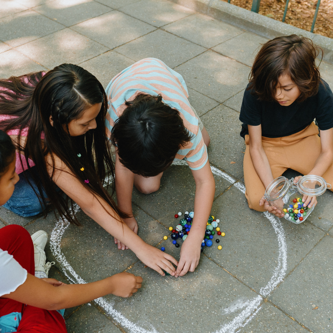 Kids playing with marbles outside