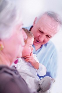 Two older people and a baby