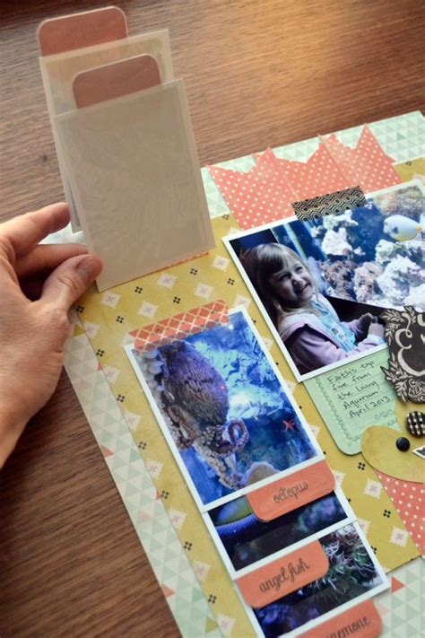 A hand touching a scrapbook page