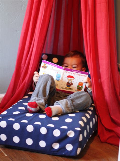 A young child reading in a cozy nook