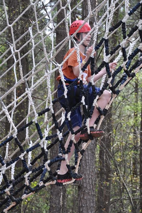 Kid climbing on rope net