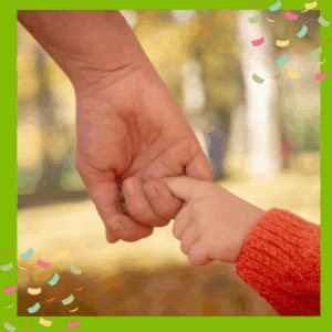 Adult holding toddler finger