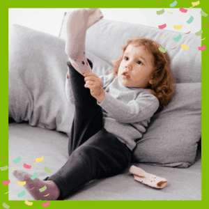 Toddler learning to put on socks