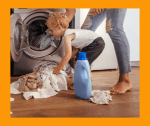 Adult and child loading items into washing machine.