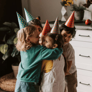 Budget friendly birthday parties: at home, group of kids wearing party hats,