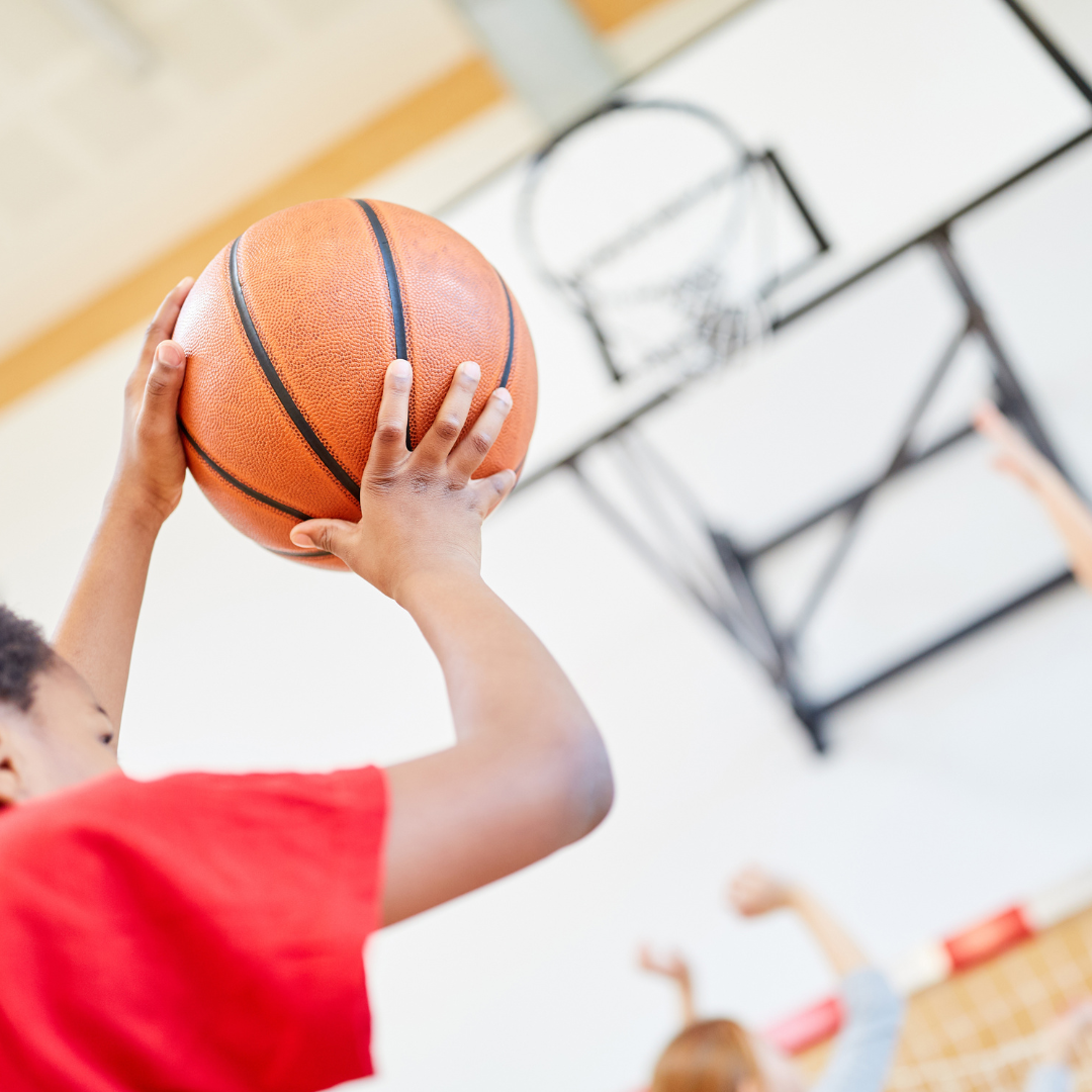 School age child playing basketball